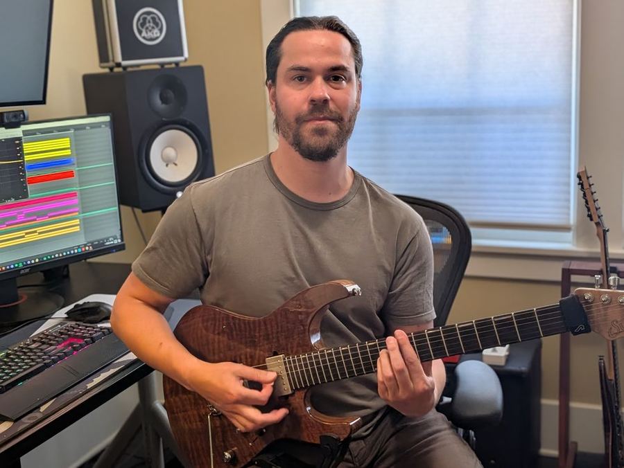 David Zuckerman playing electric guitar in his home recording studio in Santa Rosa
